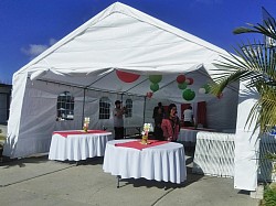 20x30 canopy with circular tables and table cloths.